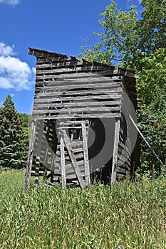 Old weathered rickety corn crib remains standing