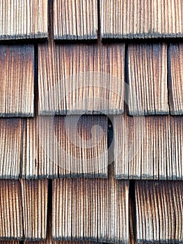 Old weathered shingles. Vertical close up, wooden texture, background for design and decoration.
