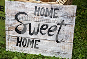 Old weathered sign with the phrase `Home sweet home`
