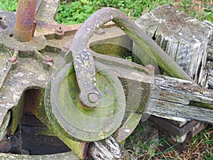 Old and weathered steel pulley in an agricultural environment