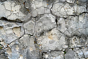 Old, weathered stone surface depicting the rough texture and impact of weather over centuries. AI generated. photo