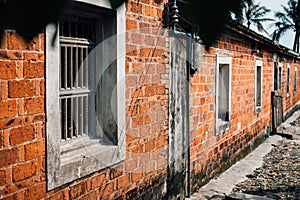 Old weathered street wall with windows.
