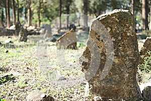 Old weathered tombstone on graveyard.