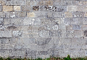 Old weathered wall made of grey bricks