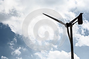 Old and weathered wind turbine generating electricity