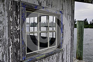 Old weathered window on a shack on a florida waterway