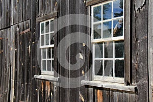 Old,weathered wood wall with glass paned windows