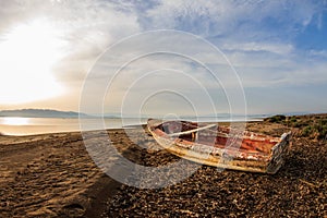 Old weathered wooden boat on the beach