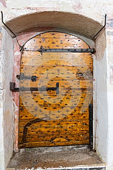 An old weathered wooden door in a thick wall