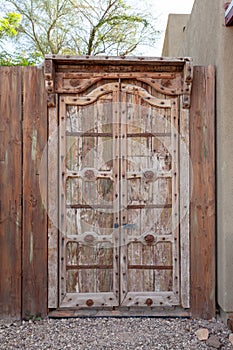 Old weathered wooden double doors closed outdoors
