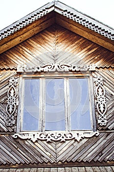 The old weathered wooden window with hinges and carved shutters. Retro