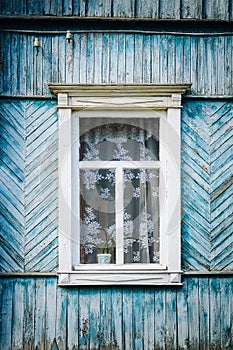 The old weathered wooden window with hinges and carved shutters. Retro