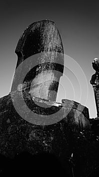 Old weathered and worn tombstone at cemetery