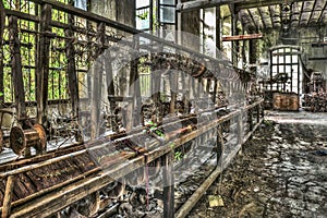 Old weaving loom and spinning machinery at an abandoned factory