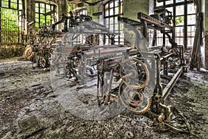 Old weaving looms and spinning machinery at an abandoned factory