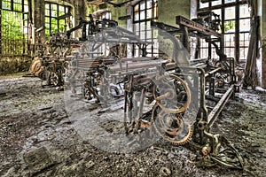 Old weaving looms and spinning machinery at an abandoned factory photo