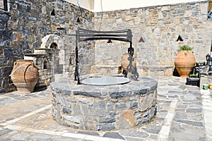 Old well with amphorae in a village