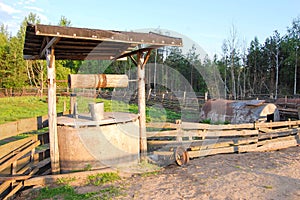 Old well with a bucket in the village on a summer day.