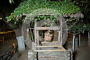 An old well and a bucket of water .old wooden well water .Old stones and wooden wells .well and bucket cutout for making composite