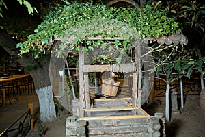 An old well and a bucket of water .old wooden well water .Old stones and wooden wells .well and bucket cutout for making composite