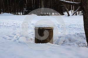 Old well in the winter meadow in forest