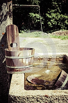 Old well and wooden bucket