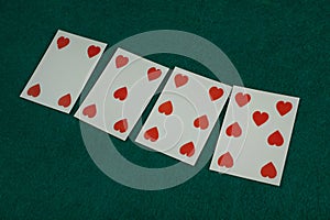 Old west era playing card on gambling table. 4, 5, 6, 7 of hearts