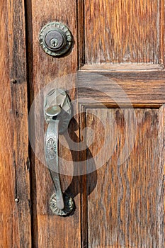 Old west USA style weathered door handle on an exterior wooden door