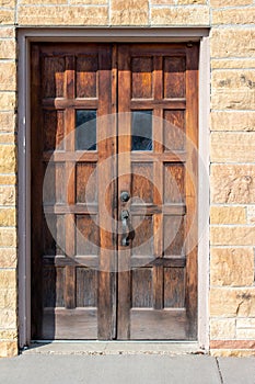 Old west USA style weathered wooden door on a stone block building stairway