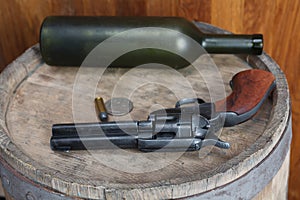 Old western revolver with cartridges and silver dollar