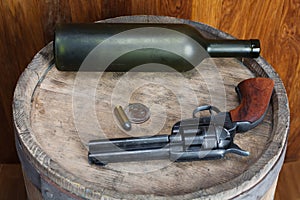 Old western revolver with cartridges and silver dollar