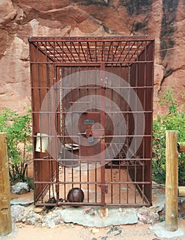Old Western rusty metal jail cell in desert