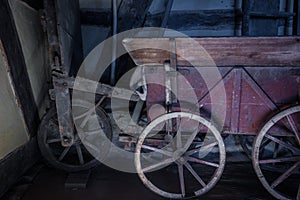 The old wheel of a cart in barn