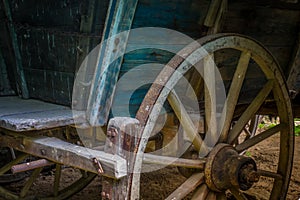 The old wheel of a cart in barn