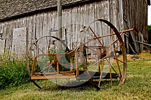 Old wheel cart in front of a weathered barn