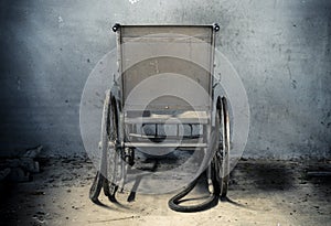 An old wheelchair in old room. old wheelchair was forsaken. this is lonely and scary concept.