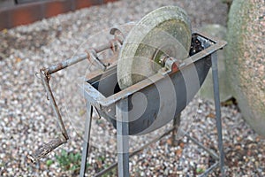 An old whetstone for sharpening knives. Grinding wheel on an old