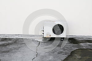 Old white air conditioner compressor. rust metal on floor