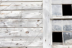 Old white barn with broken window