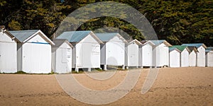 Old white beach huts photo