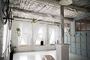 Old white bicycle whist on a white stone wall.