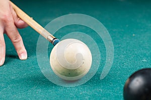 Old white billiard ball and stick on a green table. billiard balls isolated on a green background