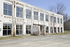 Old white brick factory building