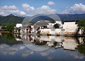 Old white building in the background of a lake in Hongcun village, China