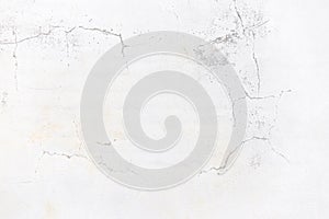 Old white cement wall background with cracks
