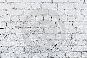 Old white concrete wall with cracks