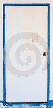 Old white door with blue jamb