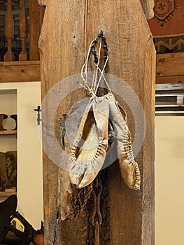 Old white leater woman shoes hanging on the wall
