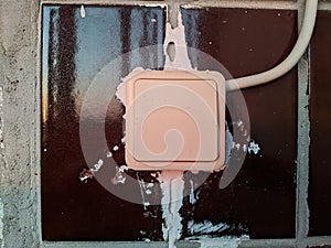 old white light switch on tile background
