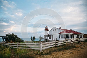 Old white lighthouse on the sea coast